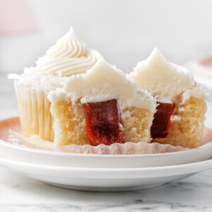Guava filled Coconut Cupcakes on a plate.