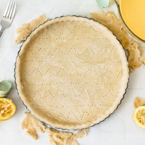 Vodka Pie Crust Recipe in a pie plate ready to bake in the oven.