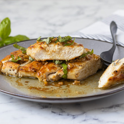 Juicy Chicken Slices topped with fresh basil and smothered in garlic sauce.