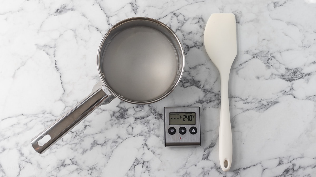 Pot with sugar water, spatula, and set digital thermometer.