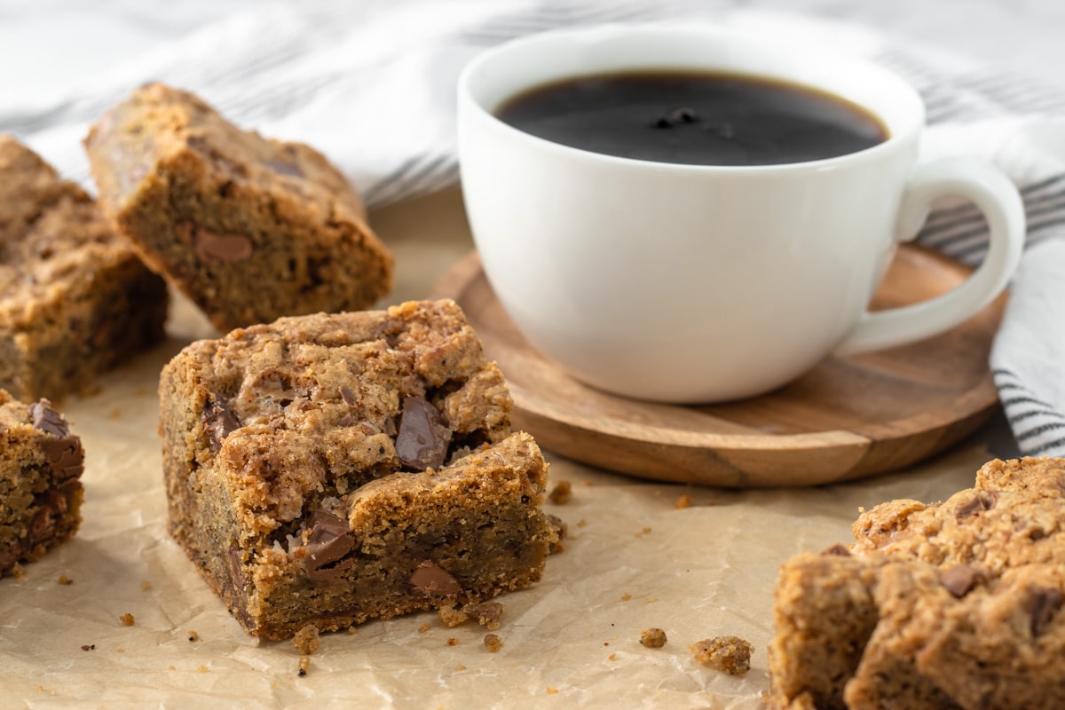 Coffee Toffee Chocolate Cookie Bars with a cup of coffee