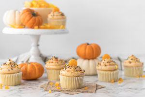 Final shot of cupcakes with butterscotch candies and pumpkins.