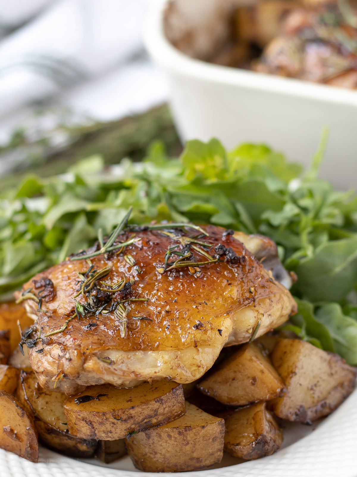 Rosemary Thyme Chicken Thighs with roasted potatoes and a side salad.