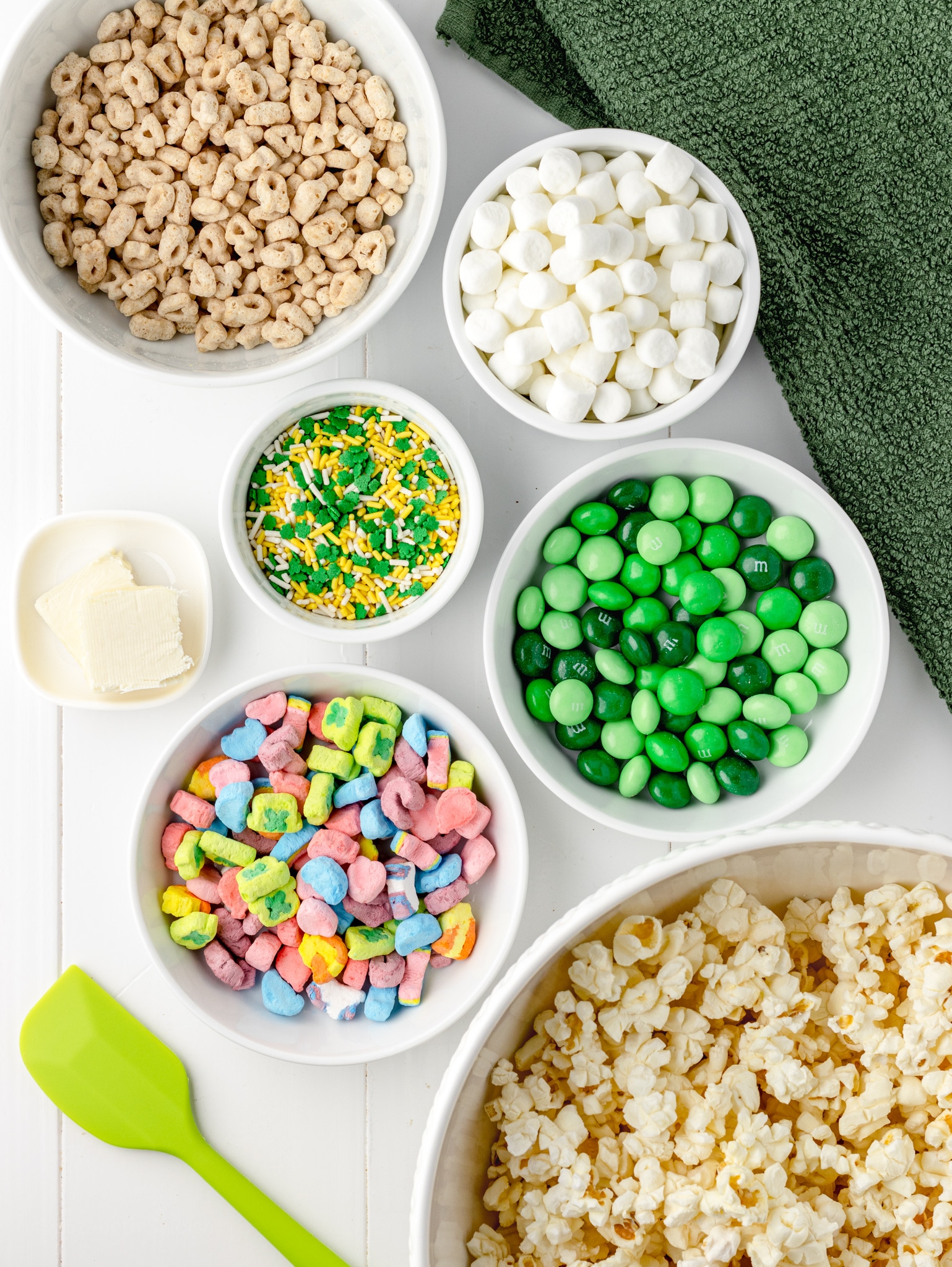 Ingredients for Loaded Leprechaun Popcorn. popcorn, lucky charms cereal, butter, mini marshmallows, butter, sprinkles.