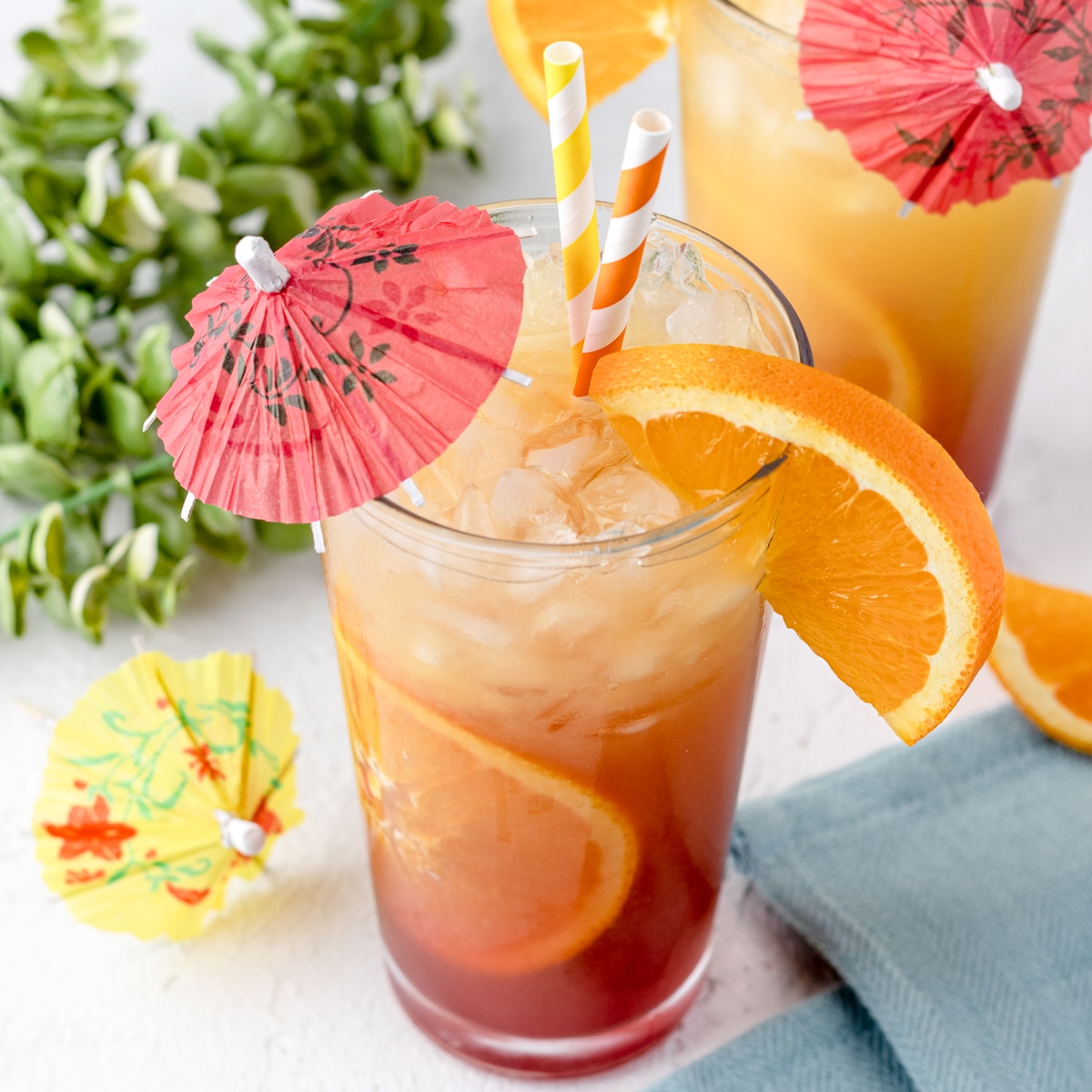 Sunrise Mocktail Spritzer with flavors of orange, pineapple, and pomegranate. Homemade grenadine recipe included.