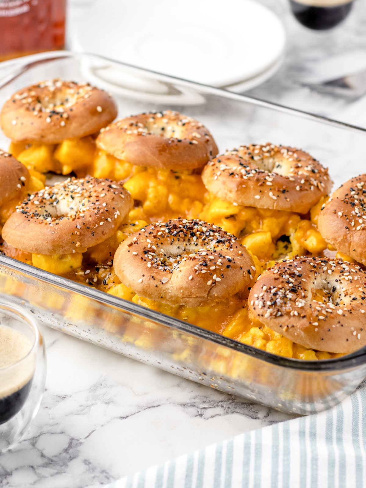Breakfast Bagel sliders fully baked  with melty cheese and toasted bagels in the pan.