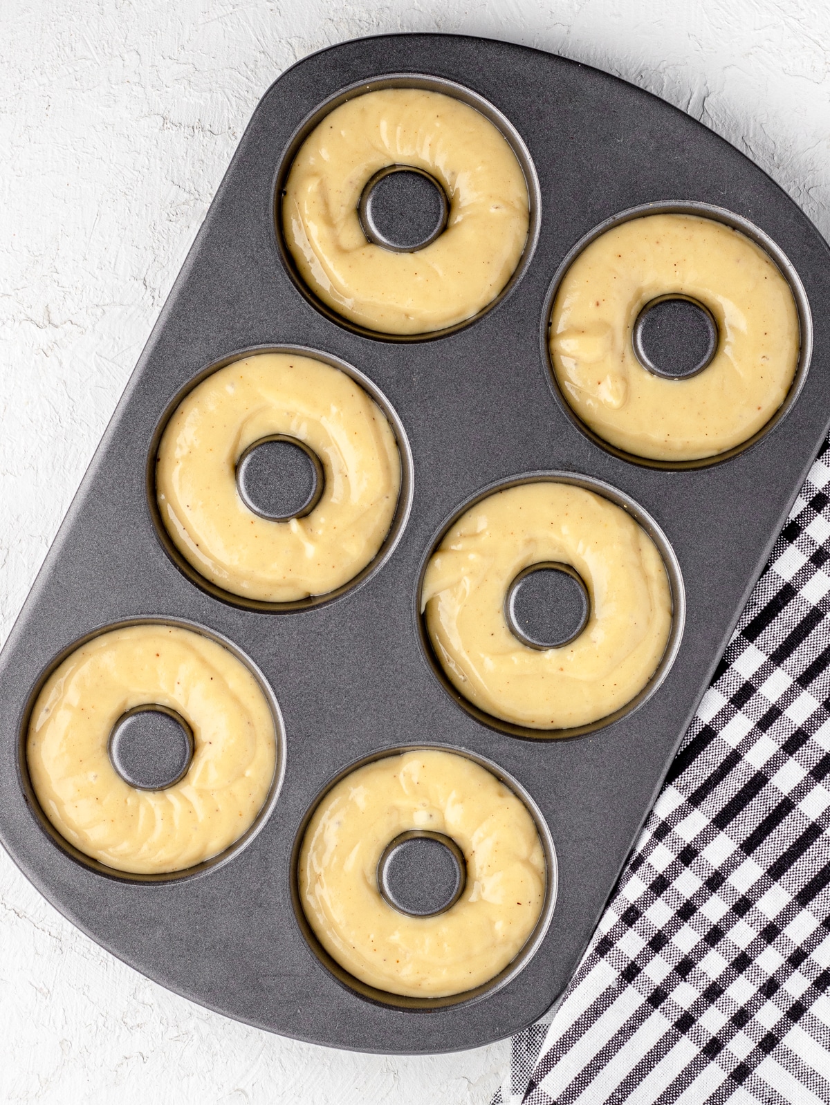 Donuts in donut pan ready to bake.