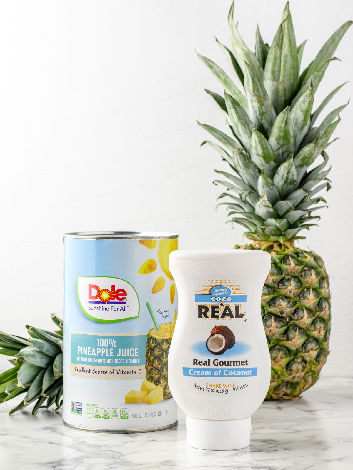Ingredients needed are pineapple chunks, pineapple juice, coconut cream, and ice. 