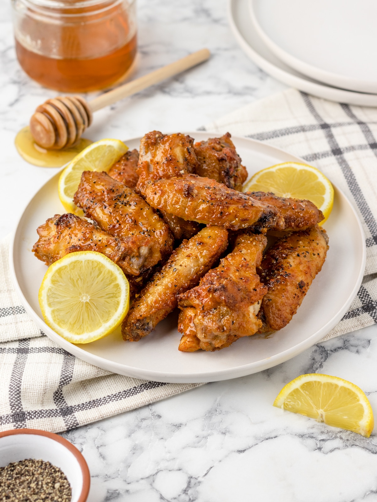 Plate stacked high with quick and easy Honey Lemon Pepper Wings.