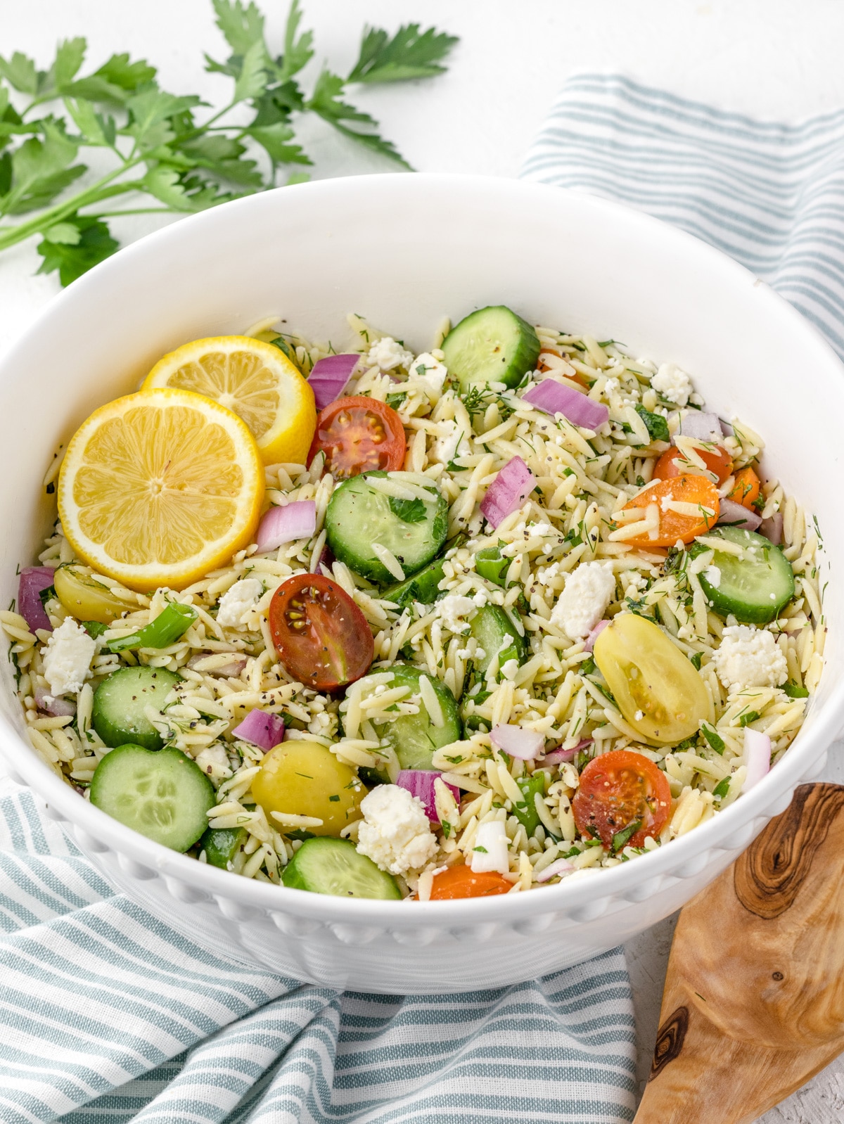 Big bowl of Lemon Orzo salad ready to be served up at a party.