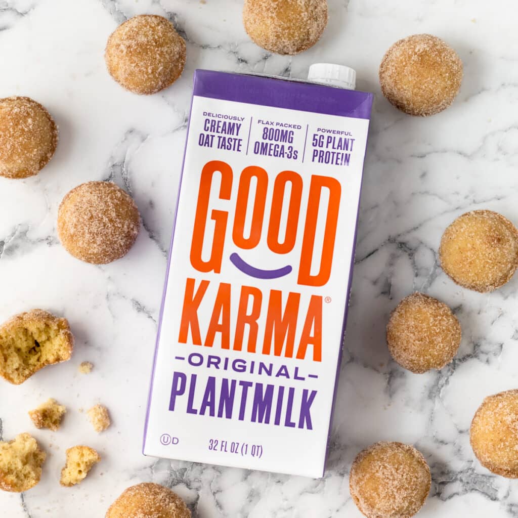 Good Karma Campaign. Container of Good Karma Plantmilk surrounded by donut holes made with the plantmilk.