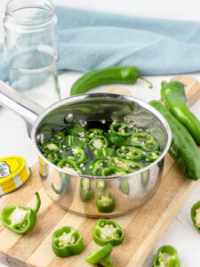 Step 3. Add the sliced jalapenos and simmer on low for 10 minutes.