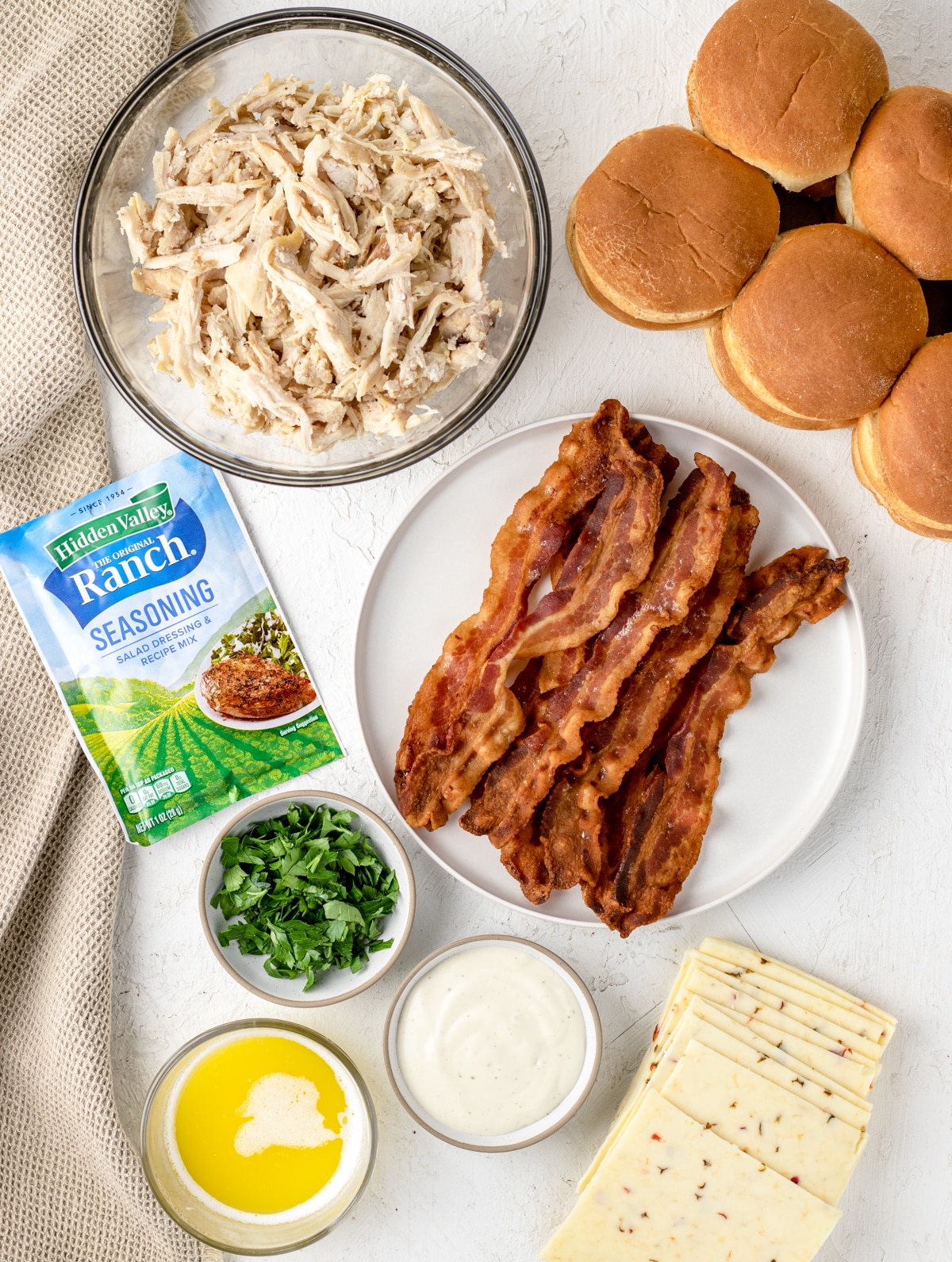 Ingredients Needed. Slider buns, shredded chicken, cooked bacon, pepper jack cheese, parsley, Ranch dressing, Ranch seasoning packet and butter.