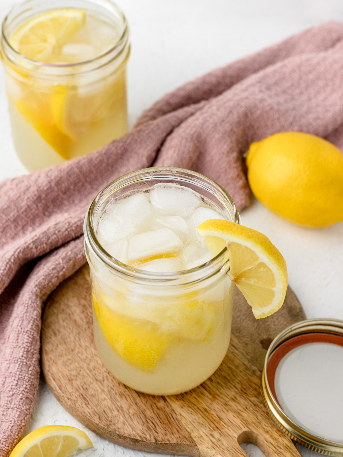Two jars of State Fair Lemonade, garnished with lemon wedges.