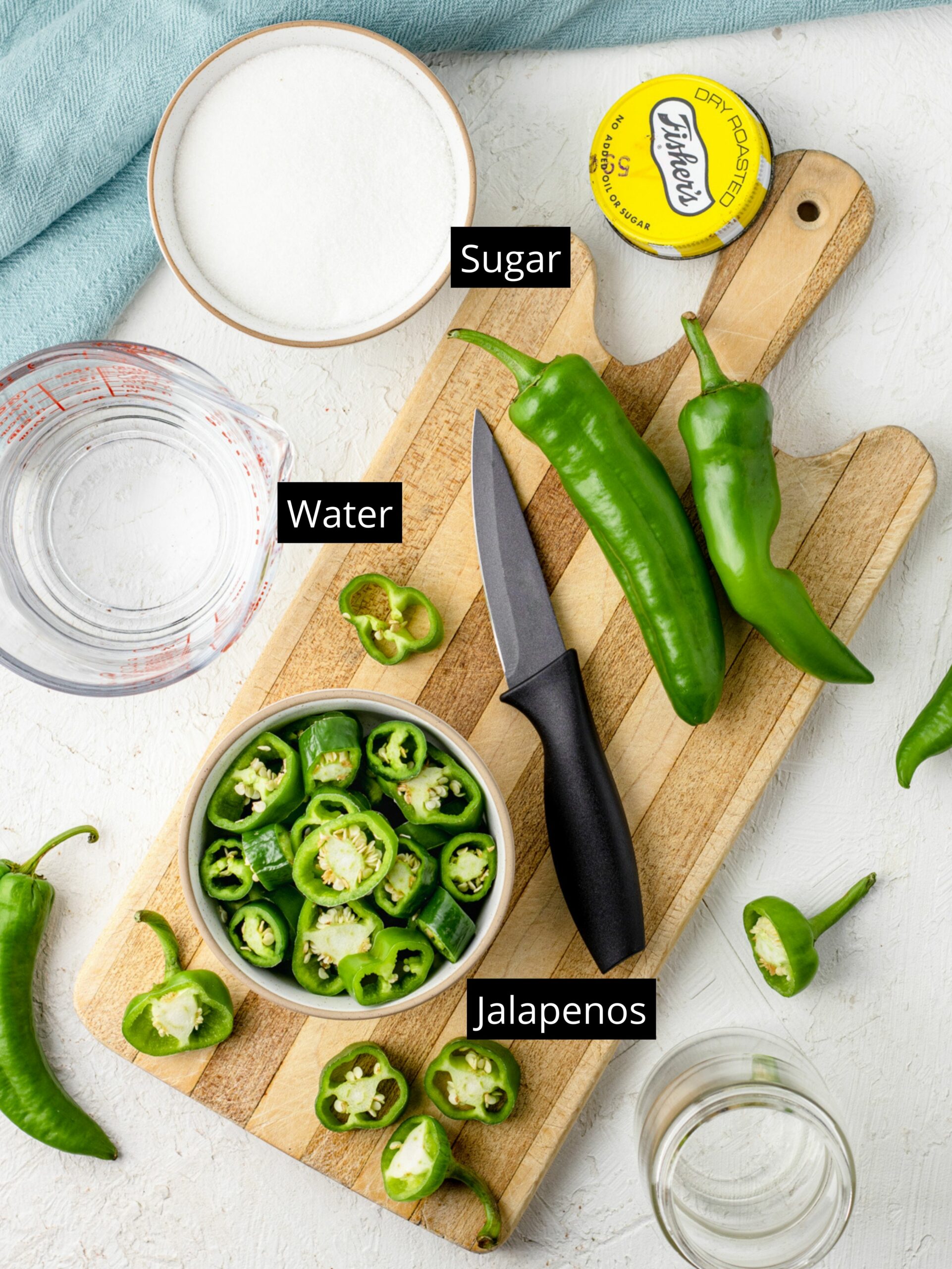 Ingredients for Jalapeno Simple Syrup: sugar, water, and sliced jalapenos with their seeds.
