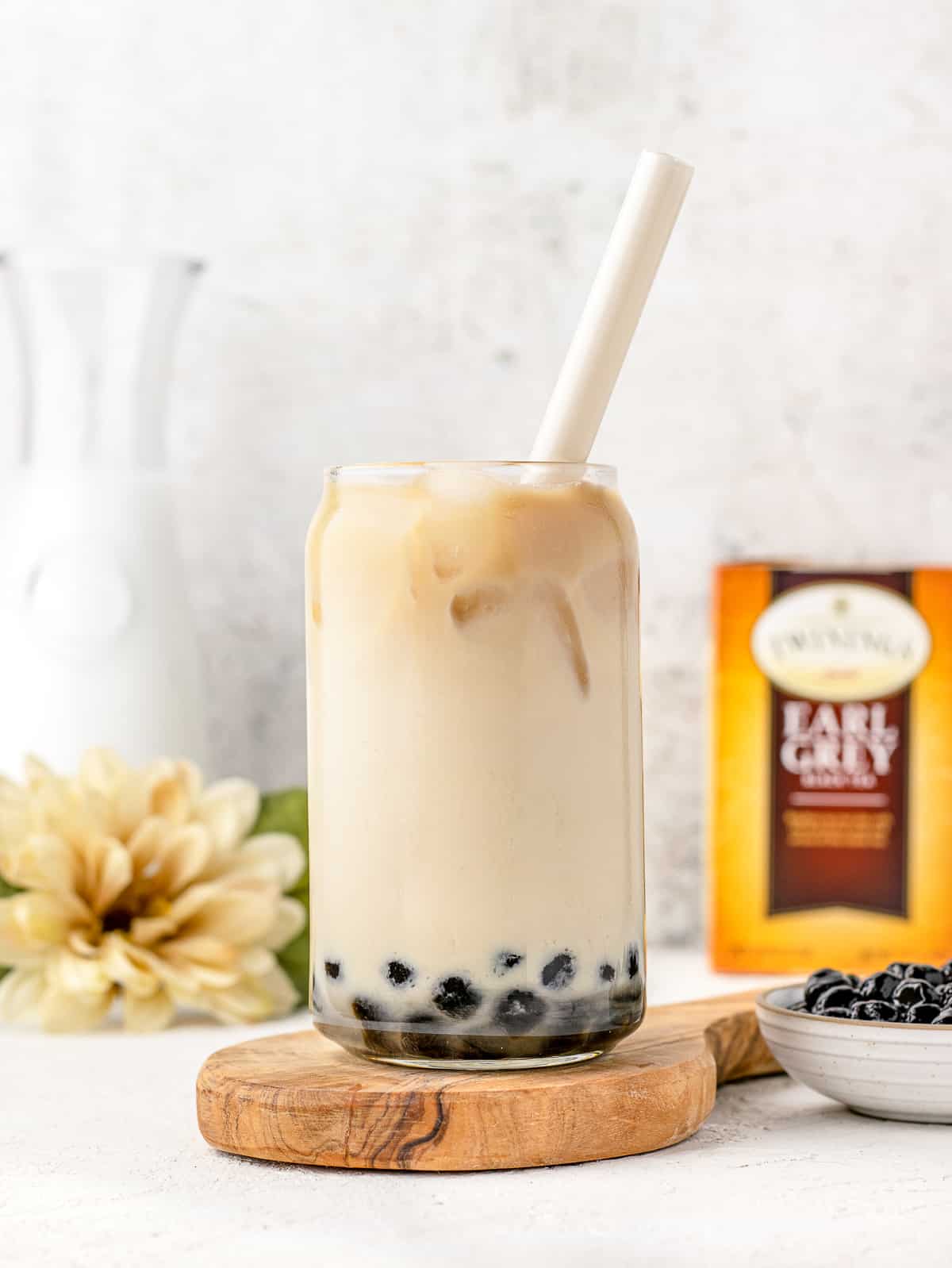 Earl Grey Milk Tea in a glass with a big straw.