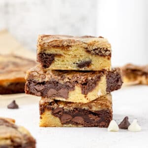 Stack of Brownie Blondies with chocolate chips and milk.