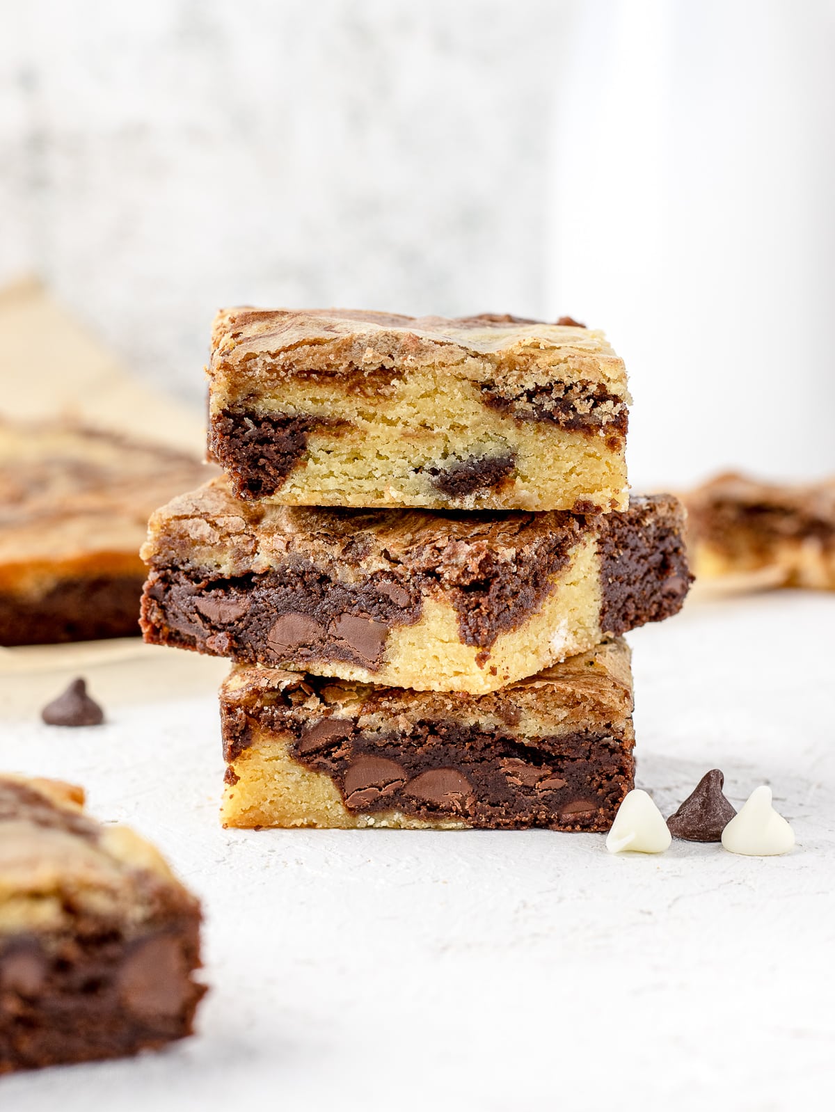 Stack of Brownie Blondies with chocolate chips and milk.