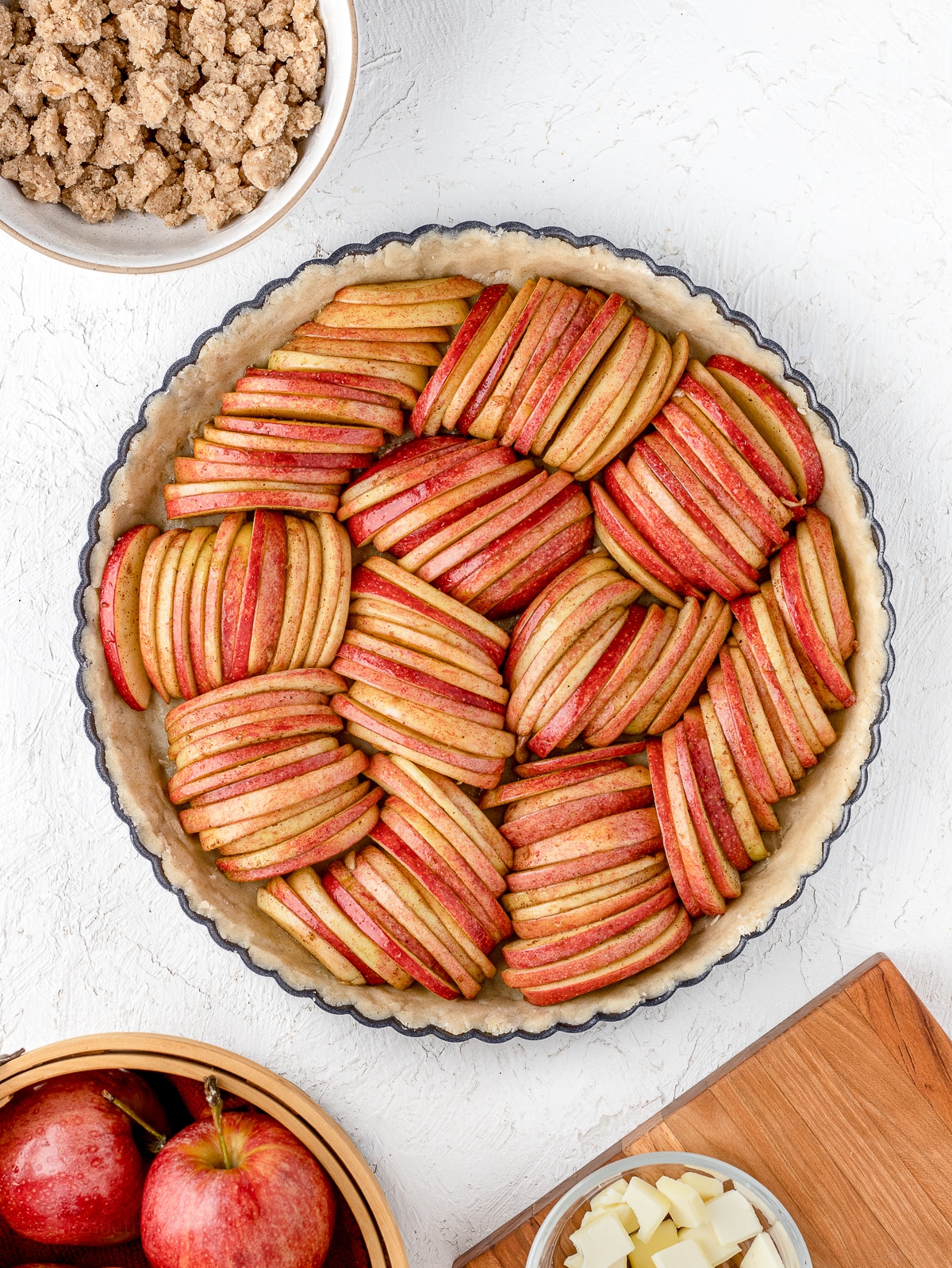 Apple slices arranged on top of the tart shell.
