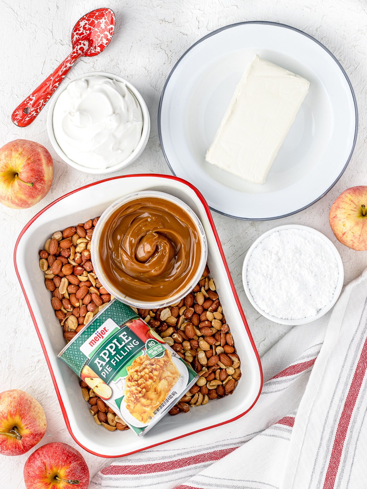 Ingredients: Cream cheese, whipped cream, powdered sugar, apple pie filling, caramel, and peanuts.