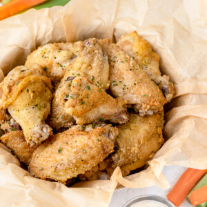 Oven Baked Chicken wings in a parchment lined basket.