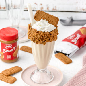 Biscoff Milkshake ready to drink with cookie butter spread on the side and more biscoff cookies.