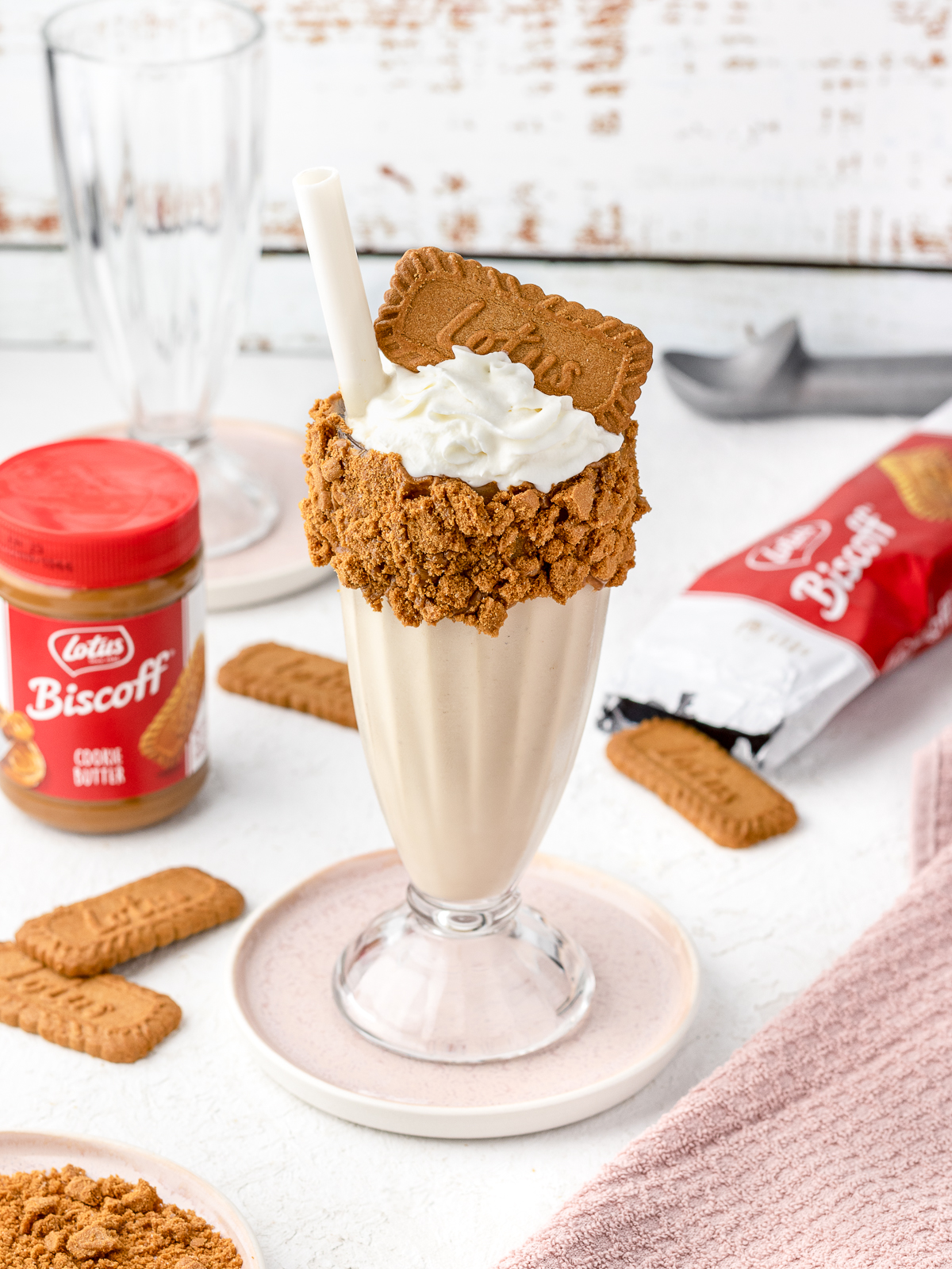 Biscoff Milkshake with cookie butter spread on the side and more biscoff cookies.