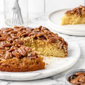 Cut out of the Pecan Upside Down Cake with a slice on the side.