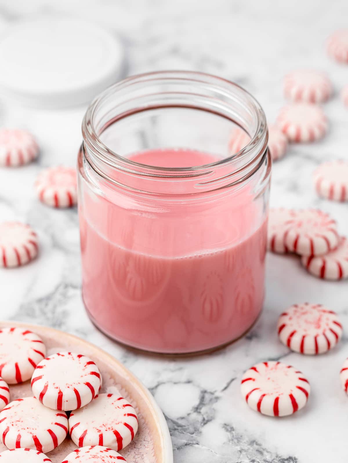 Light pink Peppermint Simple Syrup ready to use in coffee, mocktails, and other holiday drinks.