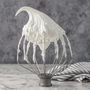 Soft, fluffy, bright white Italian Meringue on a wire whisk.