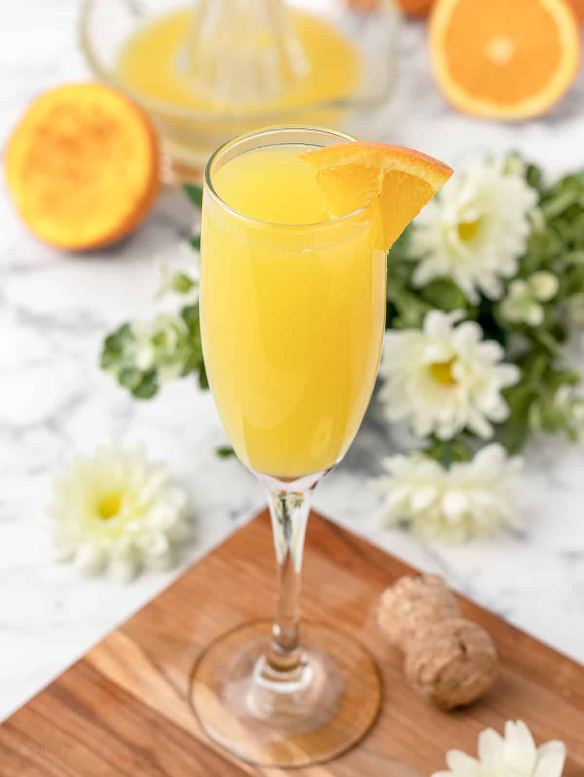 Classic mimosa with an orange wedge garnish.
