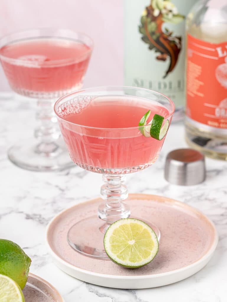 2 pink Non Alcoholic Cosmos with lime garnishes.