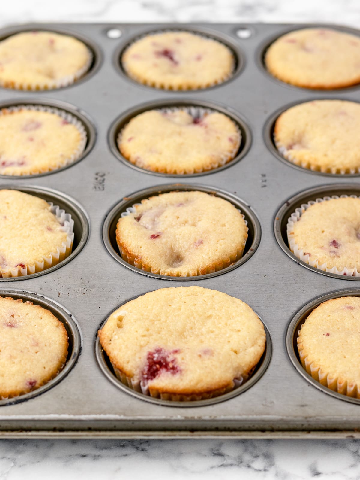 Baked cupcakes in cupcake baking pan, right out of the oven.