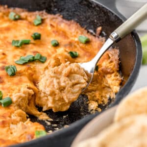 Hot and cheesy Smoked Buffalo Chicken Dip on a spoon ready to serve.