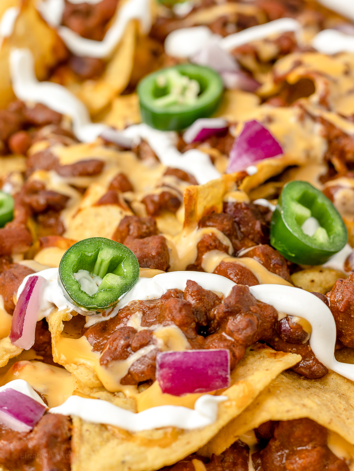 Close up of loaded nachos ready to eat.