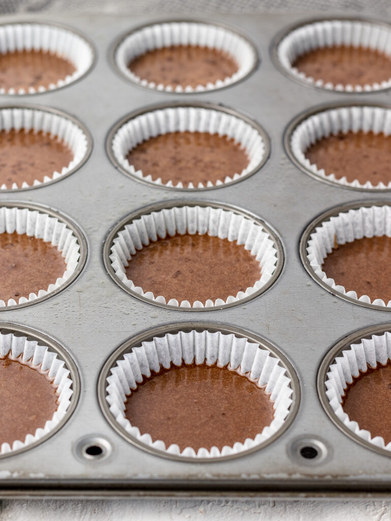 Chocolate cupcake batter in baking pan ready to go in the oven.