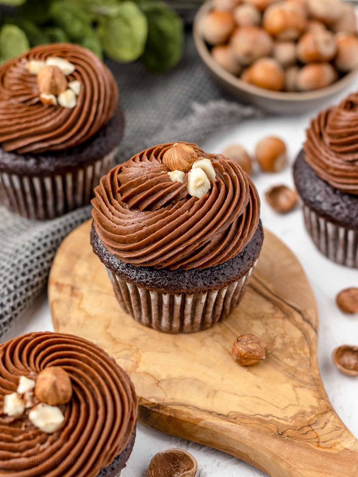 Nutella cupcakes topped with Nutella buttercream and toasted hazelnuts.