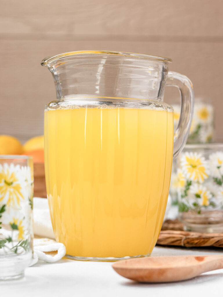 Orange Lemonade in a large pitcher ready to pour and drink.