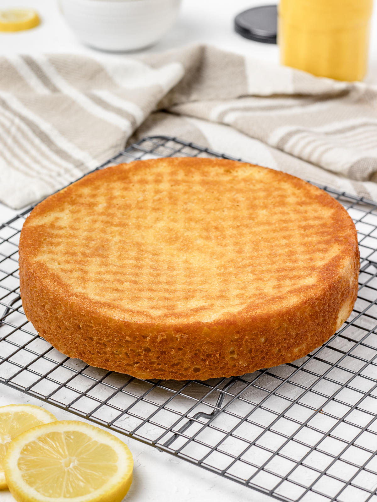 Baked lemon cake cooling on a wire rack.