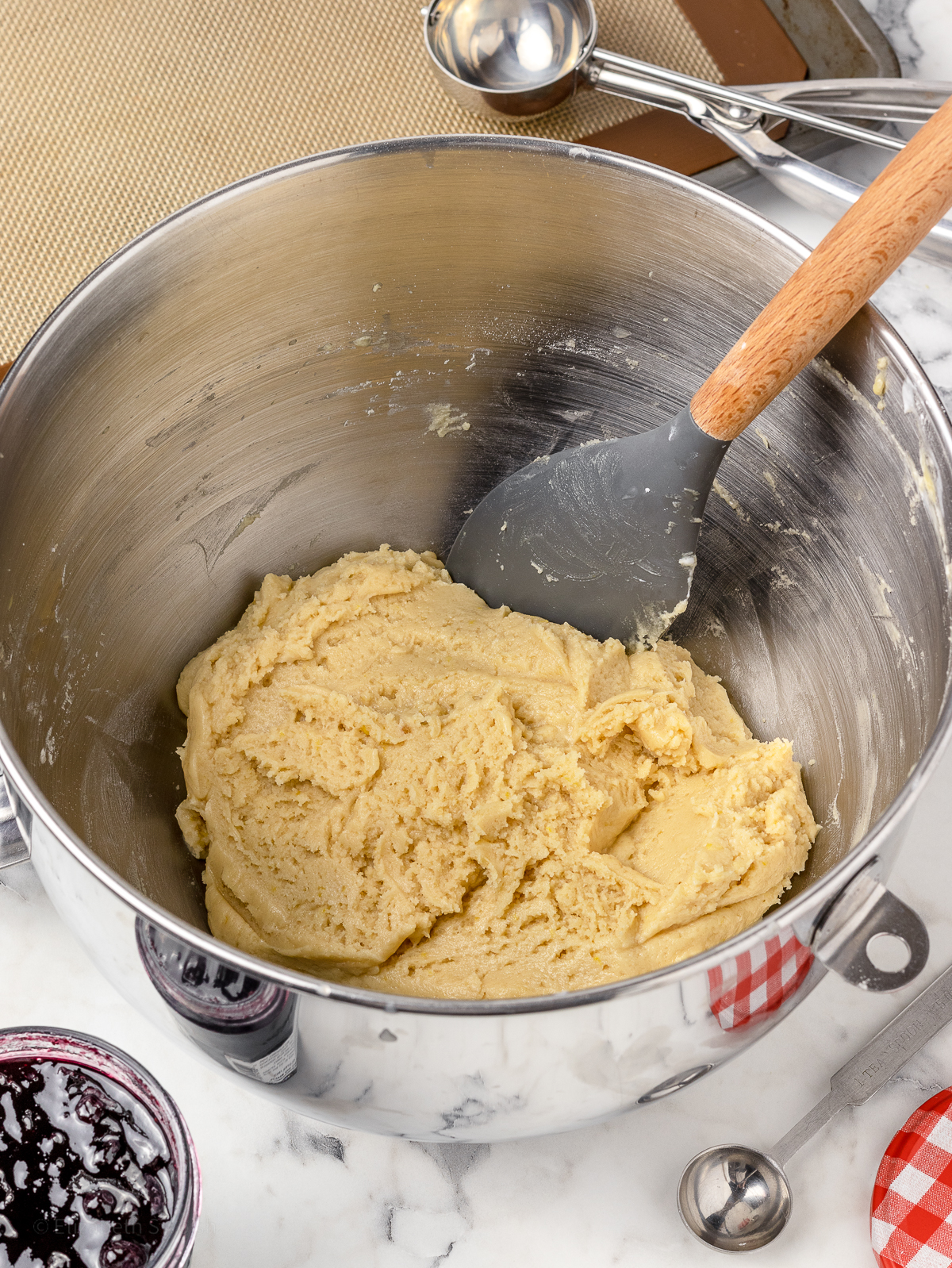 Lemon cookie dough mixed together in a mixing bowl, ready to chill in the refrigerator.