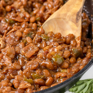 Close up of Smoked Baked Beans with bacon, onion, and green bell pepper.