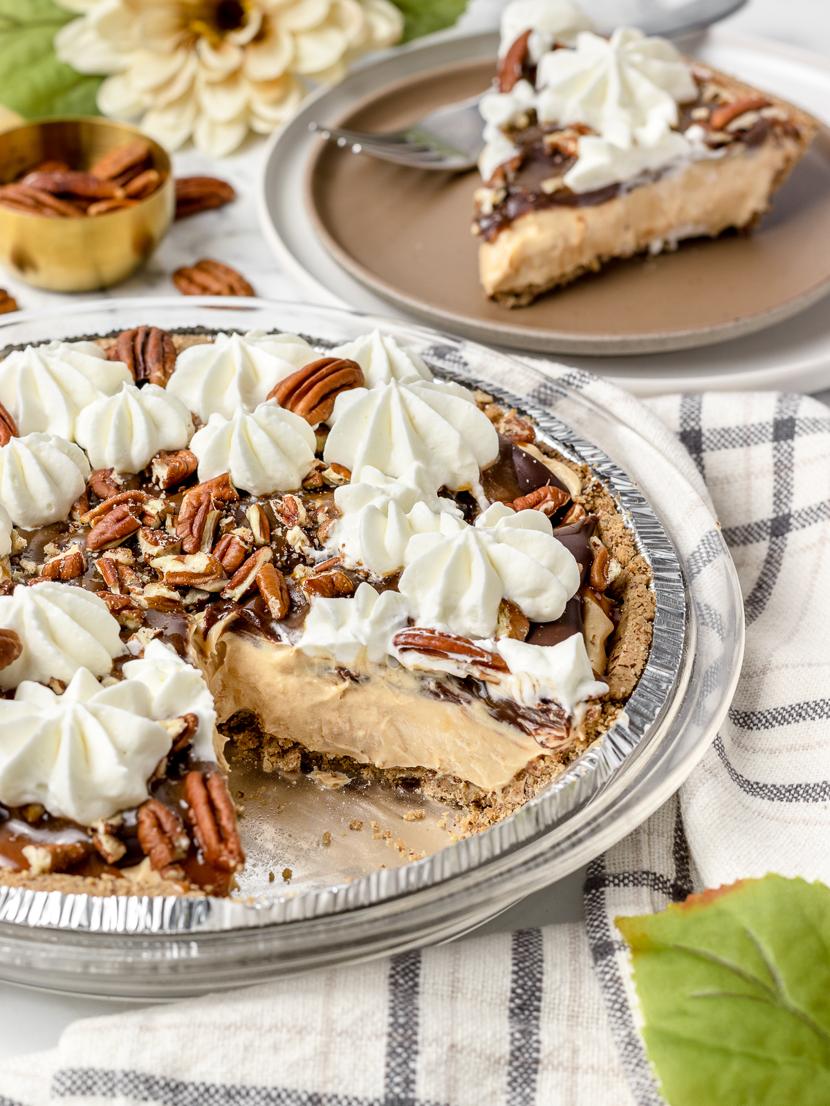 No bake turtle pie with one slice removed and on a plate in the background ready to eat.
