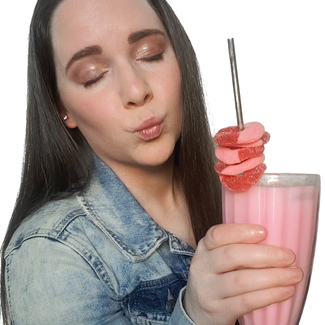Picture of Elizabeth holding a pink milkshake garnished with candy.