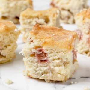Close up of tender rhubarb snack cake with chunks of rhubarb.