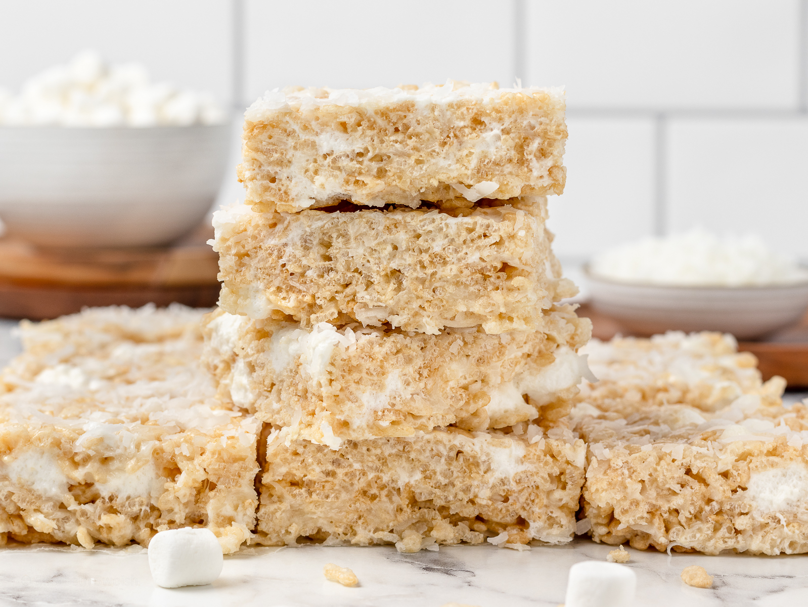 Stack of marshmallow Rice Krispie Treats topped with coconut.