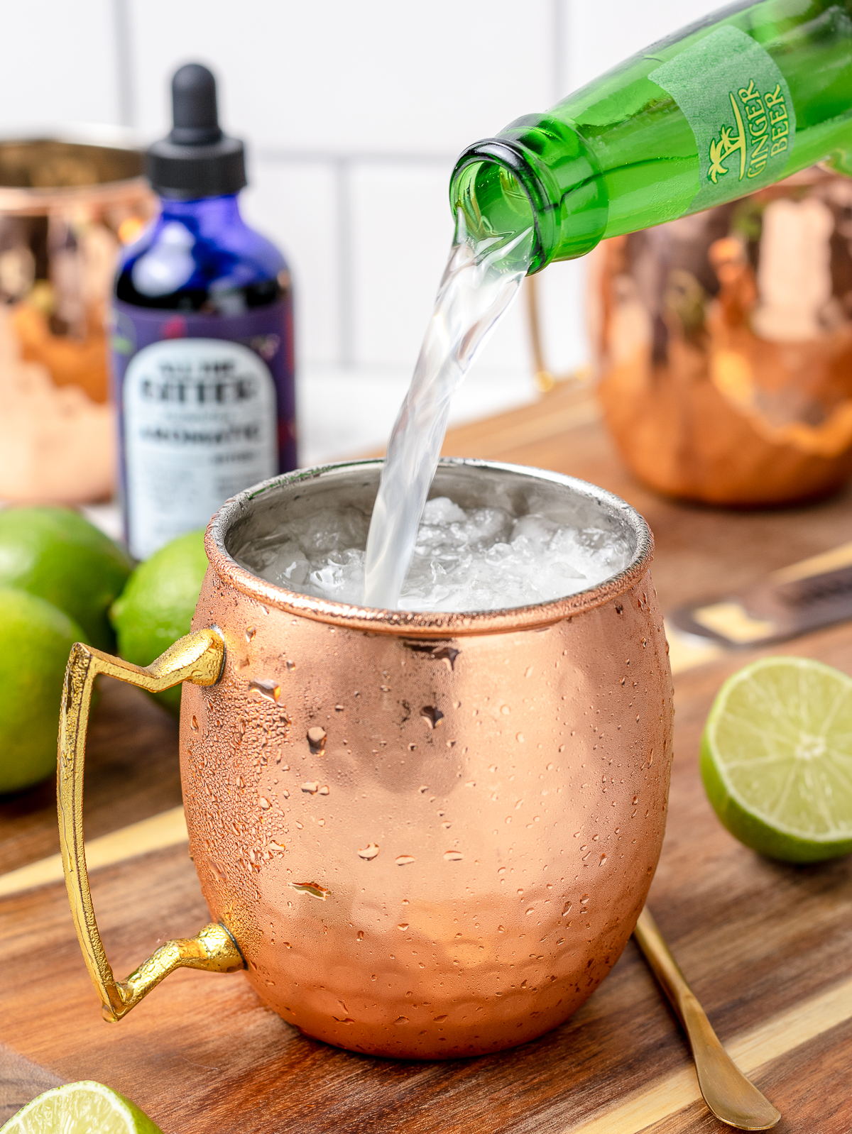 Pouring Ginger Beer into Moscow Mule Mocktail