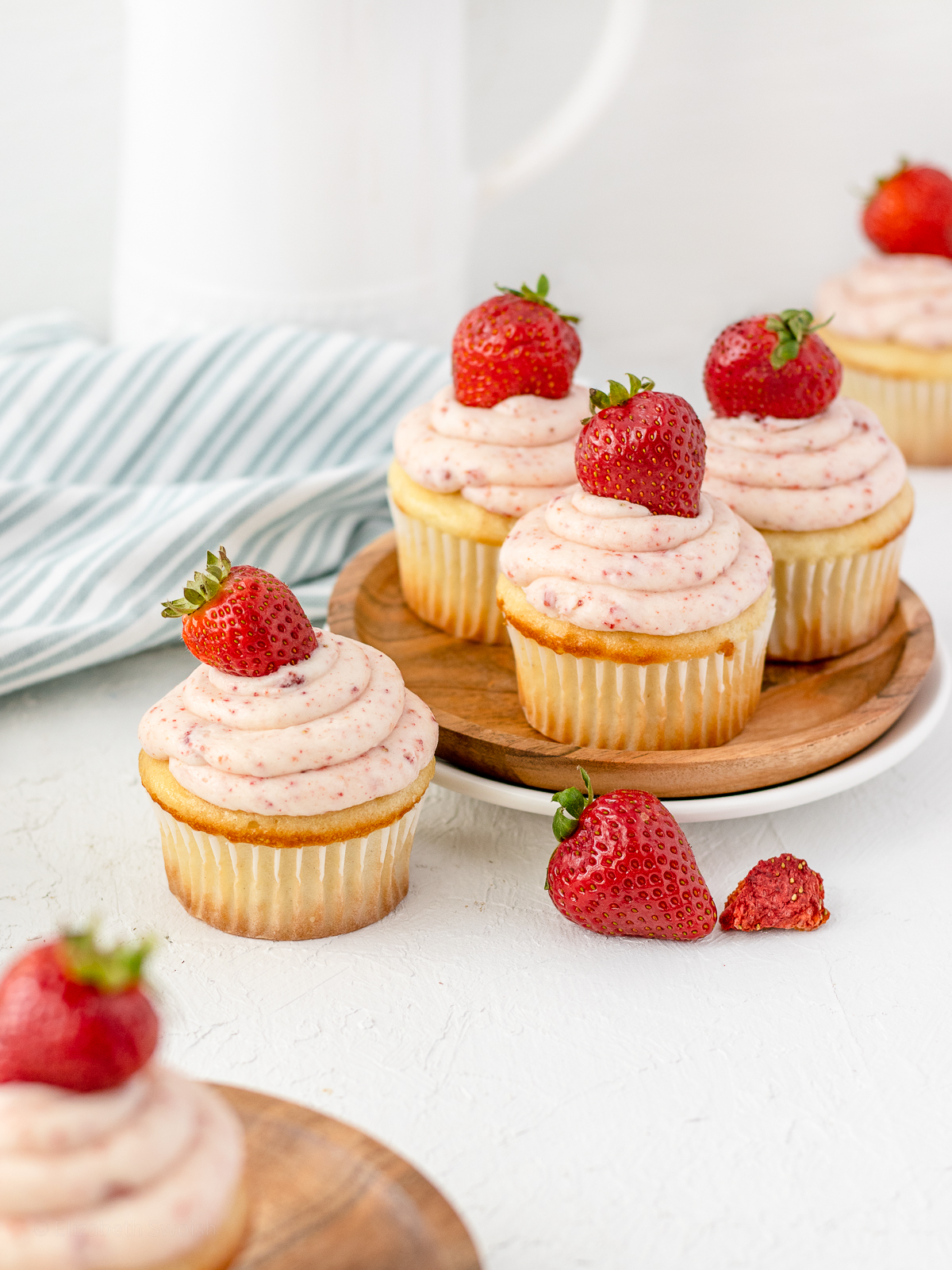 Vanilla cupcakes filled with strawberry jam and topped with a strawberry buttercream and fresh strawberry.
