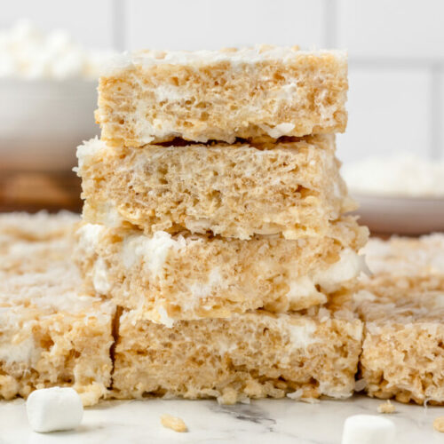 Tall stack of marshmallow Rice Krispie Treats with coconut.