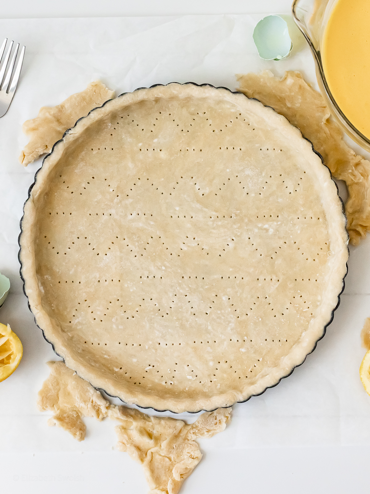 Vodka Pie Crust pressed into a pie plate and ready to par bake and blind bake in the oven.
