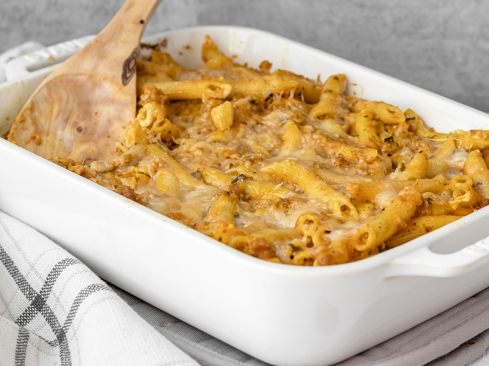 Large baking dish filled with cheesy pumpkin pasta.
